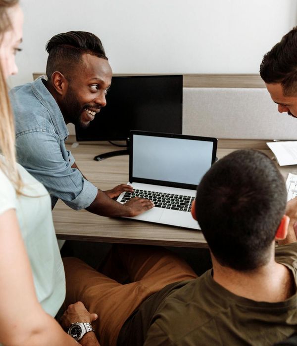 Professional team meeting discussing sustainable building project plans and blueprints